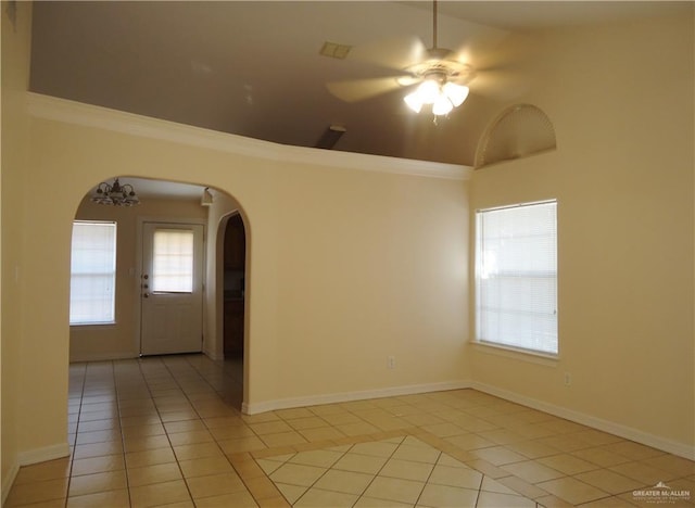 unfurnished room featuring ceiling fan, a healthy amount of sunlight, and light tile patterned flooring