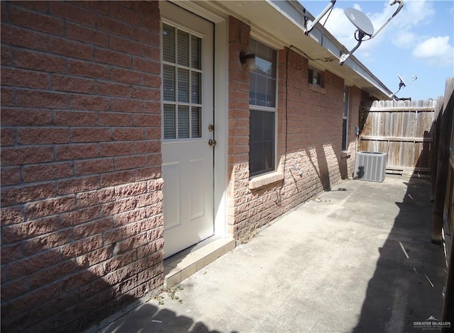 doorway to property with a patio area and central AC