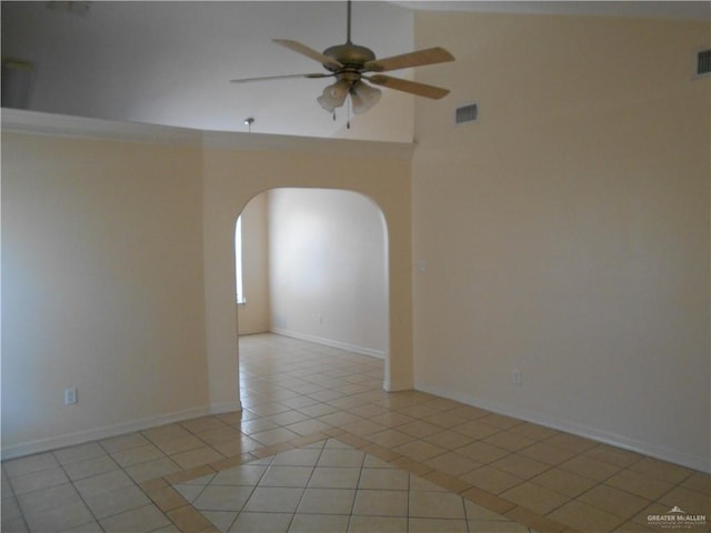 tiled spare room with ceiling fan