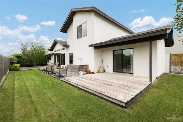 rear view of property with outdoor lounge area, stucco siding, and a wooden deck