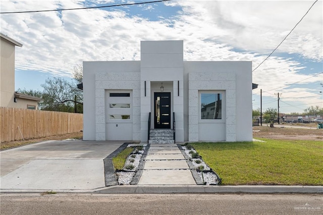 modern home featuring a front lawn