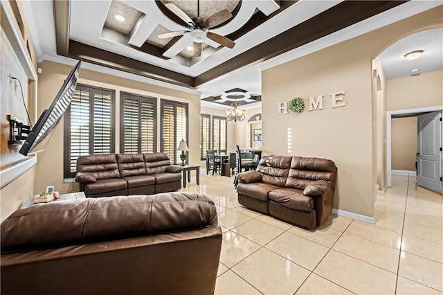 tiled living room featuring crown molding, ceiling fan with notable chandelier, coffered ceiling, and a tray ceiling