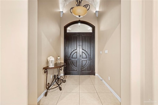 doorway to outside with light tile patterned floors