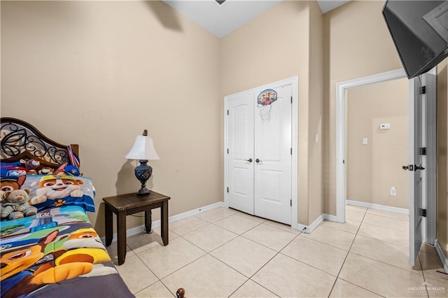 tiled bedroom with a towering ceiling