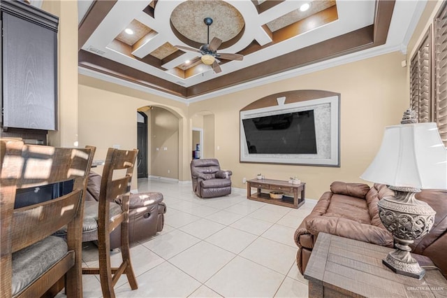 living room with ceiling fan, light tile patterned floors, ornamental molding, and coffered ceiling