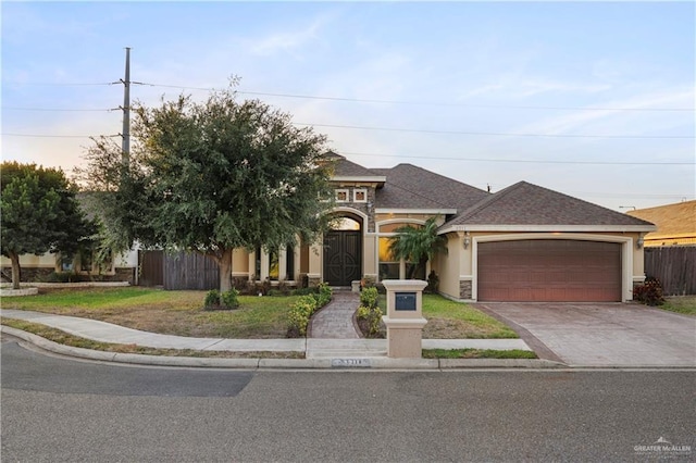 view of front facade with a garage and a yard