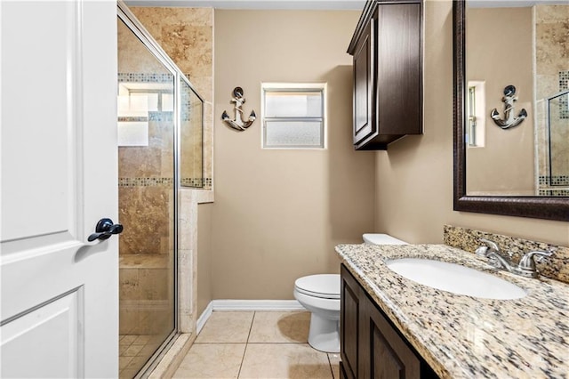 bathroom with tile patterned floors, a shower with door, toilet, and vanity