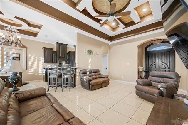 living room with ceiling fan with notable chandelier, light tile patterned flooring, a tray ceiling, crown molding, and coffered ceiling