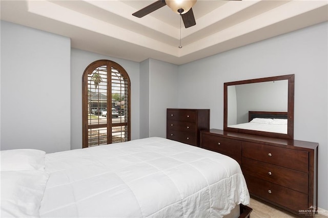 bedroom featuring a tray ceiling and ceiling fan