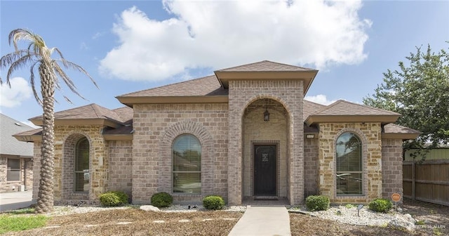 512 Frost Proof Dr, Weslaco, TX 78599 - view of front of home featuring a shingled roof and brick siding