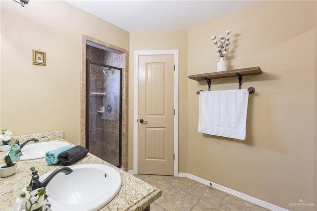 512 Frost Proof Dr, Weslaco, TX 78599 - bathroom featuring vanity, a shower stall, tile patterned flooring, and baseboards