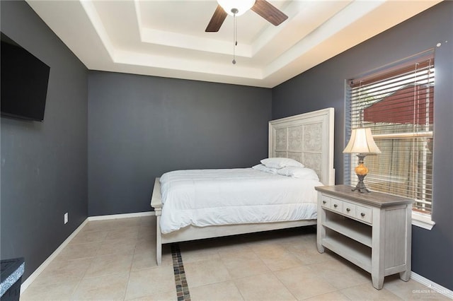 512 Frost Proof Dr, Weslaco, TX 78599 - bedroom with a tray ceiling, light tile patterned flooring, ceiling fan, and baseboards