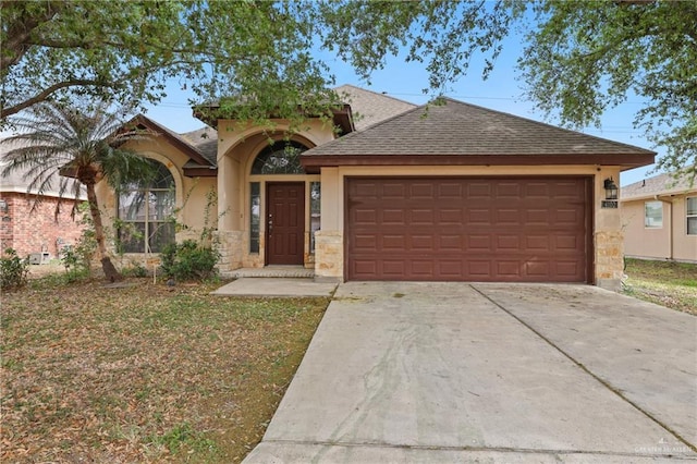 view of front of home featuring stucco siding, stone siding, concrete driveway, an attached garage, and a shingled roof