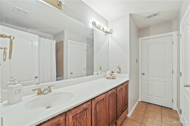 bathroom with tile patterned floors, visible vents, a shower with curtain, and vanity
