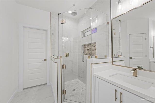 bathroom with marble finish floor, a marble finish shower, and vanity