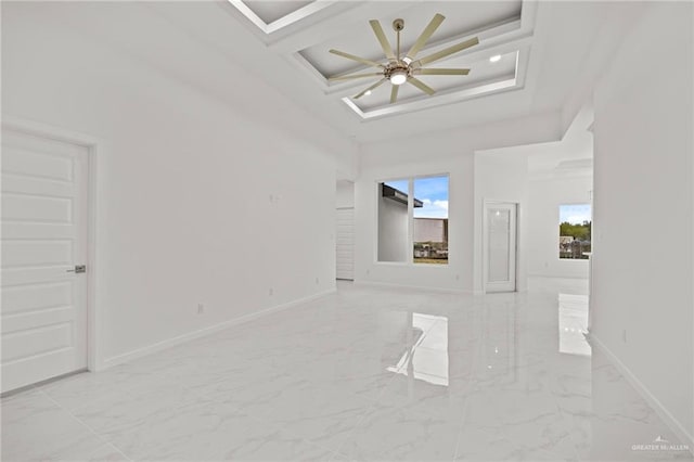 interior space featuring marble finish floor, coffered ceiling, and baseboards