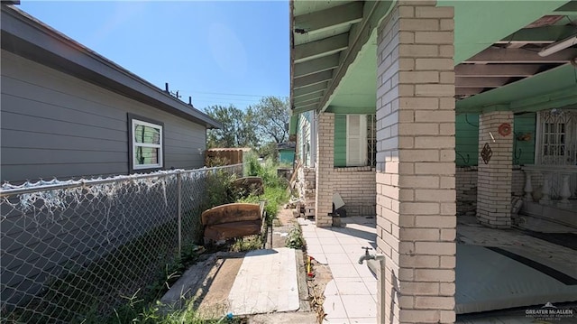 view of side of home with a patio area