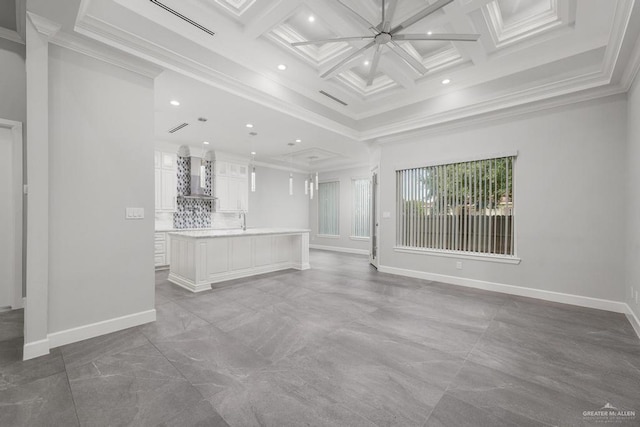 unfurnished living room with coffered ceiling, ceiling fan, crown molding, sink, and beamed ceiling