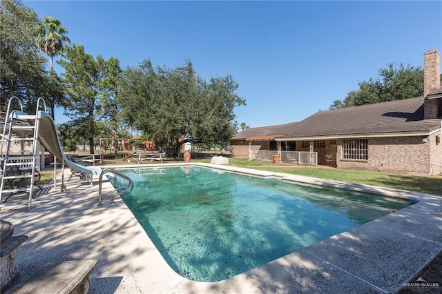 view of swimming pool with a water slide