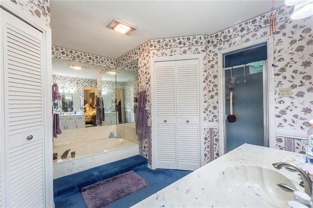 bathroom featuring a washtub and vanity