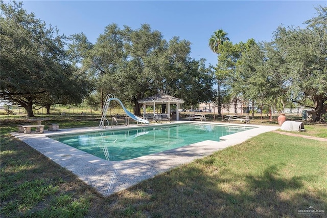 view of pool with a gazebo, a yard, and a water slide