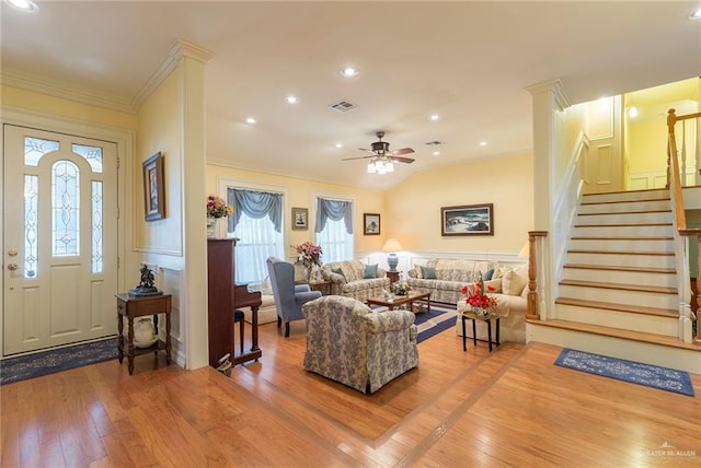 living room with hardwood / wood-style floors, ceiling fan, and ornamental molding