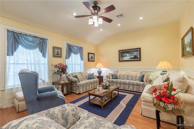 living room featuring ceiling fan, lofted ceiling, crown molding, and light hardwood / wood-style flooring