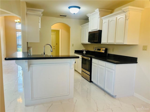 kitchen featuring stainless steel range with electric stovetop, white cabinetry, and kitchen peninsula