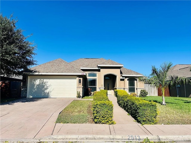 view of front of property featuring a garage and a front yard