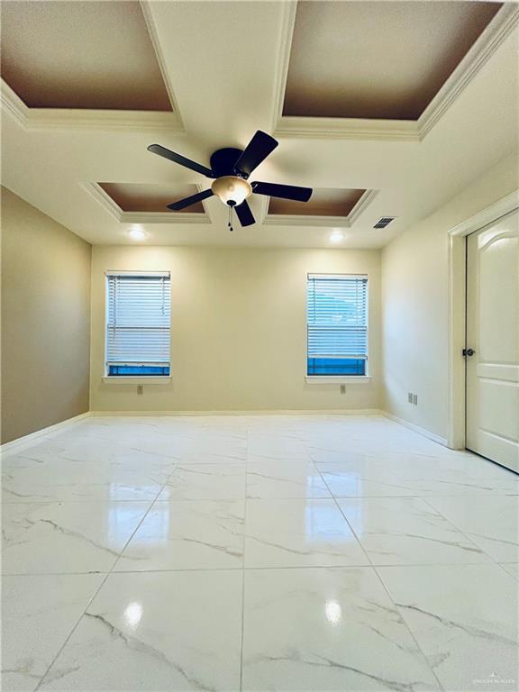 unfurnished room with crown molding, ceiling fan, and a tray ceiling