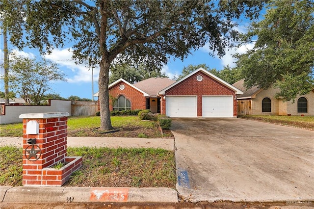 ranch-style home with a front yard and a garage