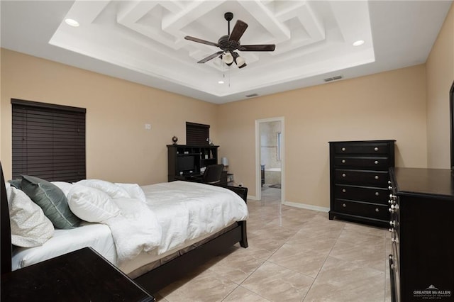 bedroom featuring visible vents, ceiling fan, baseboards, and a tray ceiling