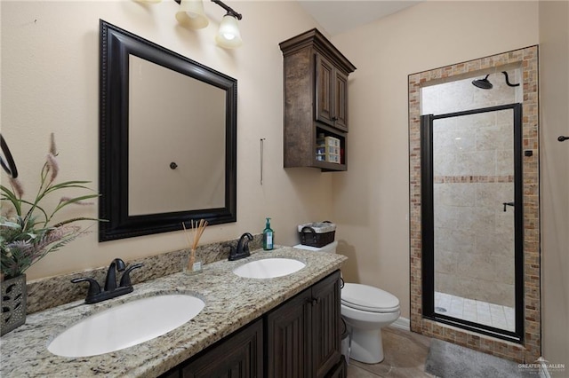 full bath with double vanity, a shower stall, toilet, and a sink