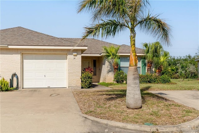 single story home featuring a garage, driveway, and a shingled roof