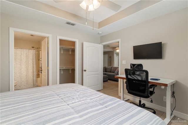 bedroom featuring a raised ceiling and ceiling fan