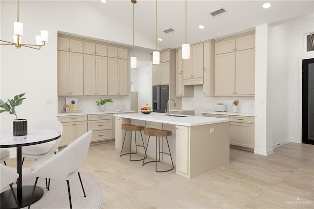 2712 E Burberry Dr, Edinburg, TX 78542 - kitchen with a sink, visible vents, black fridge with ice dispenser, and cream cabinetry