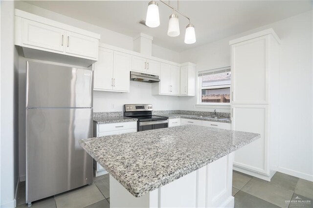 kitchen featuring white cabinets, appliances with stainless steel finishes, a center island, and pendant lighting