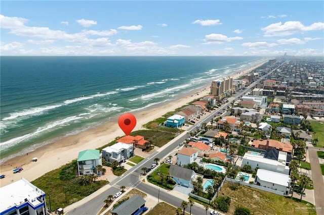 birds eye view of property with a view of the beach and a water view