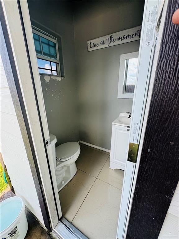 bathroom featuring tile patterned flooring, vanity, and toilet