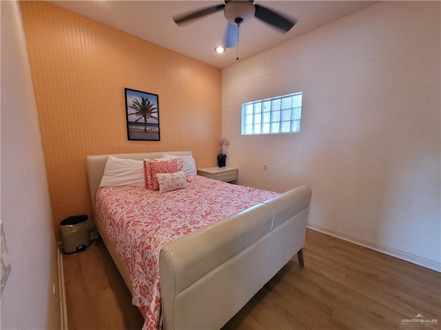 bedroom with a ceiling fan and wood finished floors