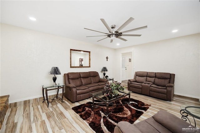 living room featuring ceiling fan and light hardwood / wood-style flooring