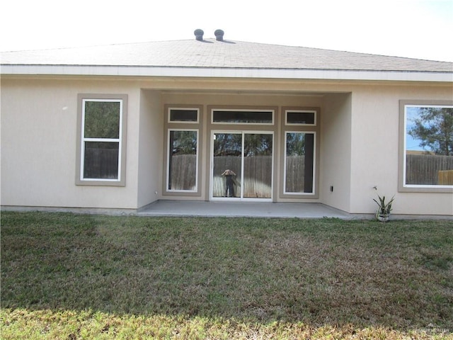 back of house with a patio area and a yard