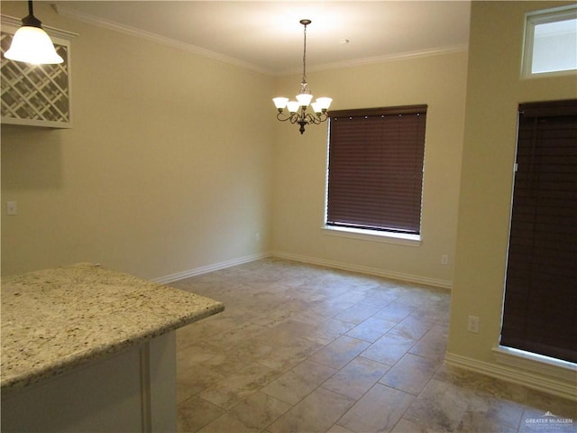 unfurnished dining area featuring ornamental molding and a notable chandelier