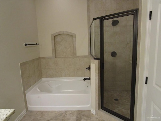 bathroom featuring separate shower and tub and tile patterned floors