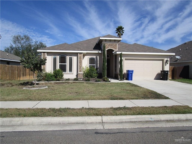 view of front of property with a front yard and a garage