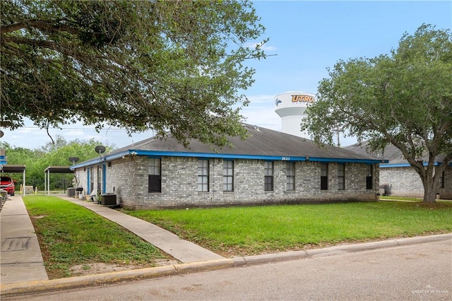 view of side of home featuring a yard, central AC unit, and a carport