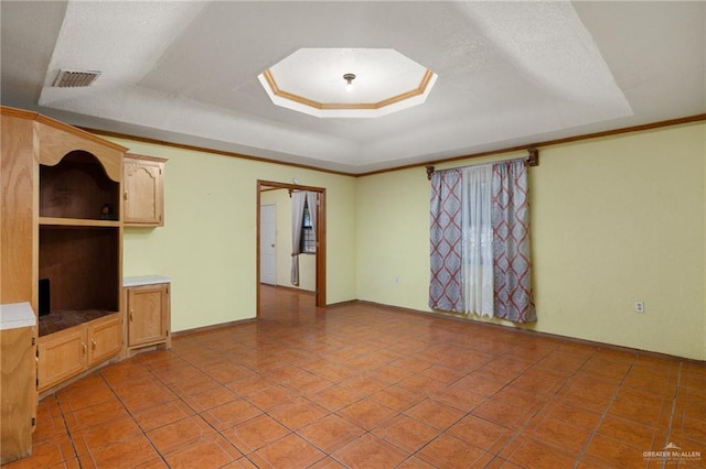 unfurnished living room with light tile patterned flooring, a raised ceiling, and ornamental molding