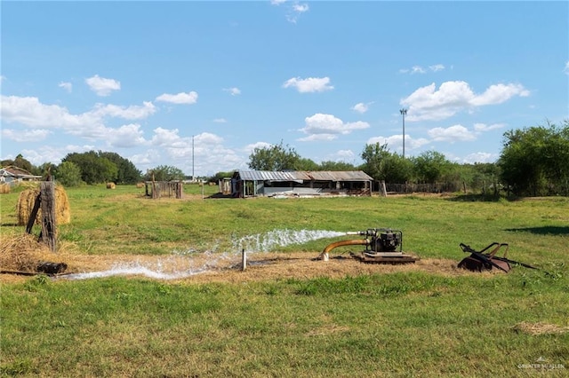 view of yard with a rural view and a water view