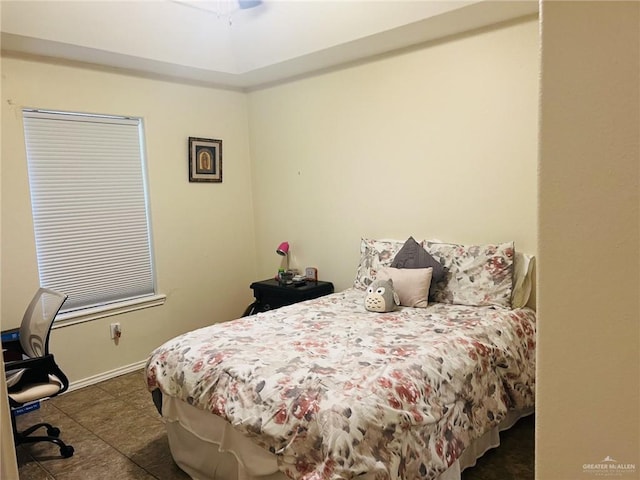 tiled bedroom with ceiling fan