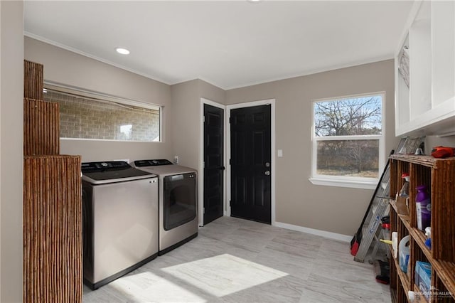 laundry area featuring cabinets, ornamental molding, and washer and clothes dryer